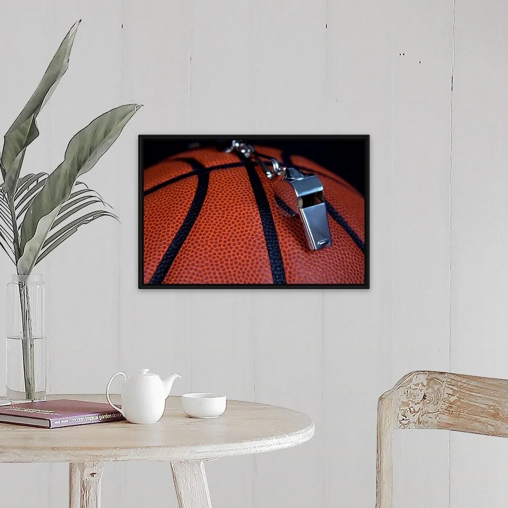 "A referee's whistle rests on top of a basketball" Black Float Frame Canvas Art