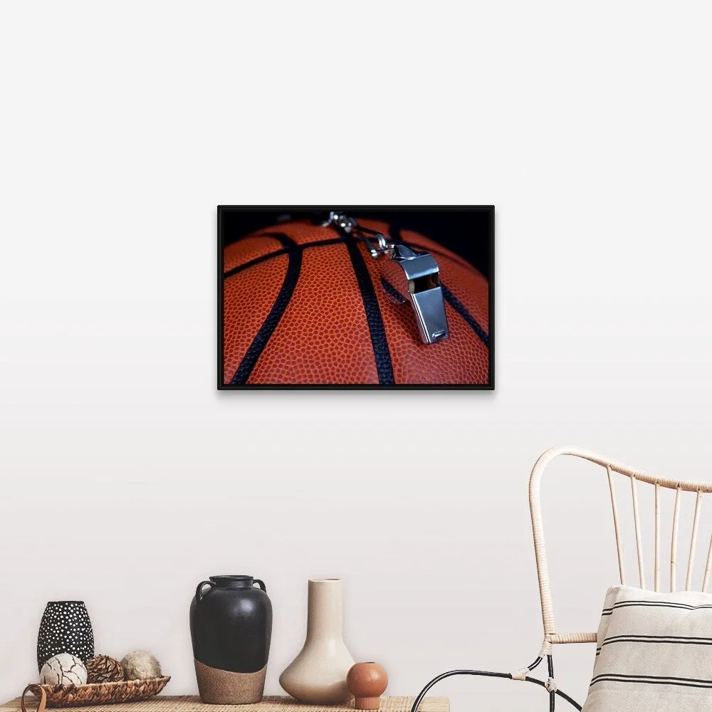 "A referee's whistle rests on top of a basketball" Black Float Frame Canvas Art