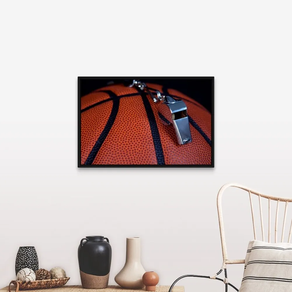 "A referee's whistle rests on top of a basketball" Black Float Frame Canvas Art