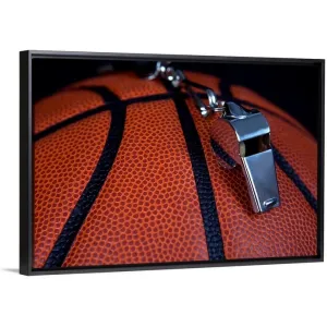 "A referee's whistle rests on top of a basketball" Black Float Frame Canvas Art