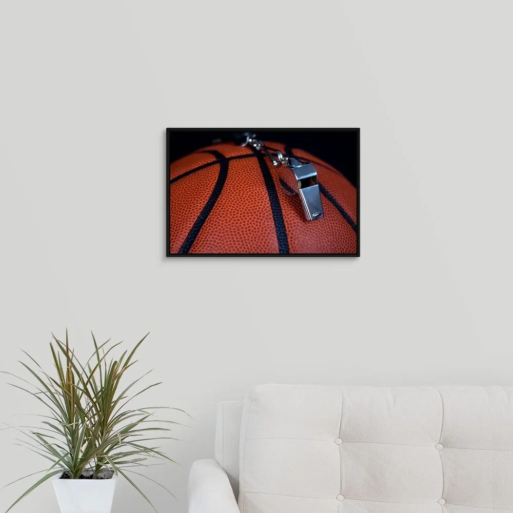 "A referee's whistle rests on top of a basketball" Black Float Frame Canvas Art