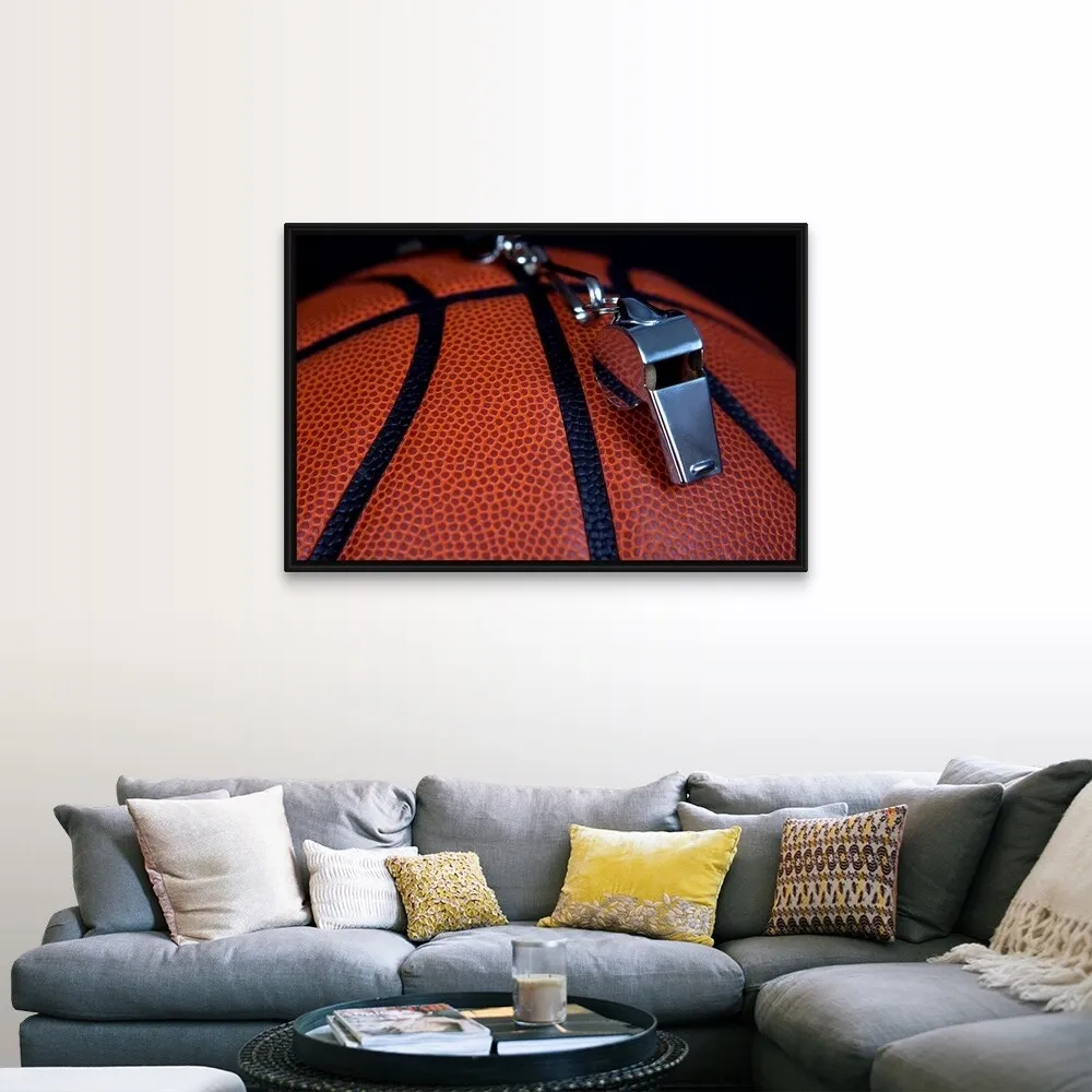 "A referee's whistle rests on top of a basketball" Black Float Frame Canvas Art